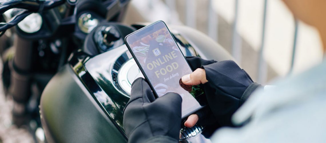 motorcyclist-ordering-food-using-online ordering-system-foodship